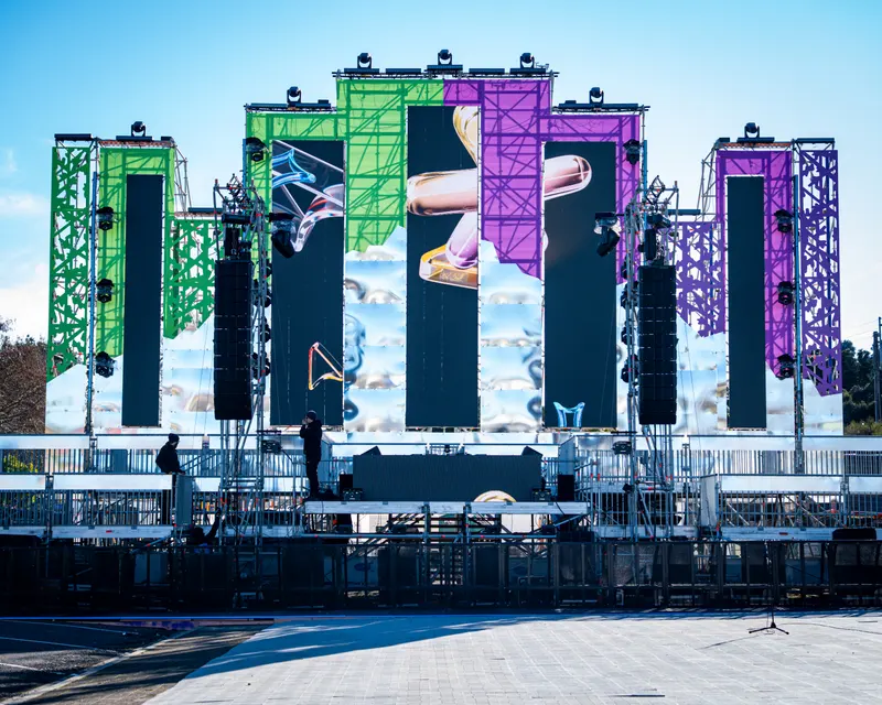 Outdoor stage with colourful panels and production equipment
