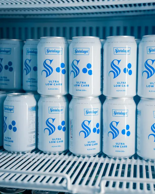 Rows of Steinlager cans inside a drinks fridge